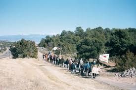 Pilgrims walk east from Los Alamos toward the Sangre de Christo Mountains.